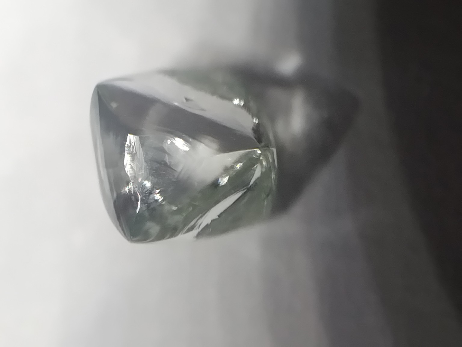 Rough diamond specimen photographed with tweezers